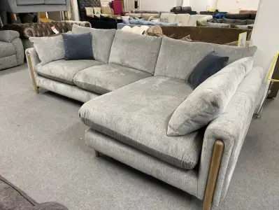 A Grey corner sofa with exposed wood frame